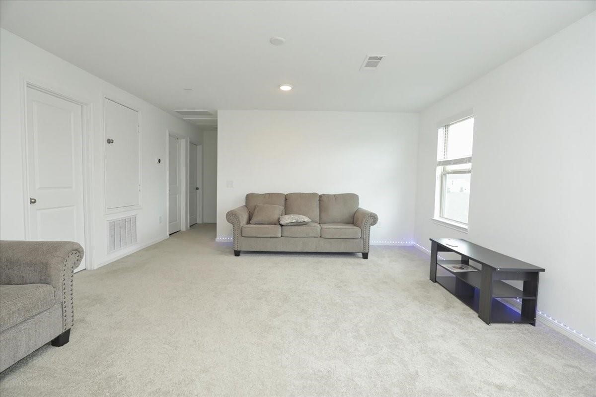 14463 Cedar Br Lane Conroe, TX 77302 - Photo 32 of 50 a living room with furniture and a couch