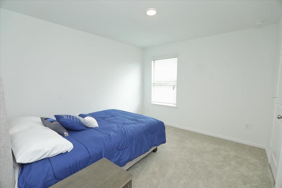 14463 Cedar Br Lane Conroe, TX 77302 - Photo 34 of 50 a bedroom with a bed and a window