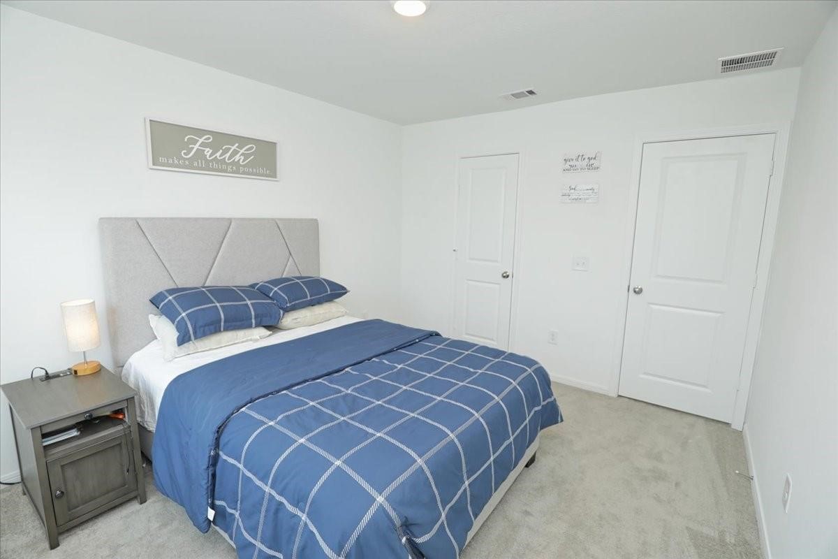 14463 Cedar Br Lane Conroe, TX 77302 - Photo 35 of 50 a bedroom with a bed and a lamp