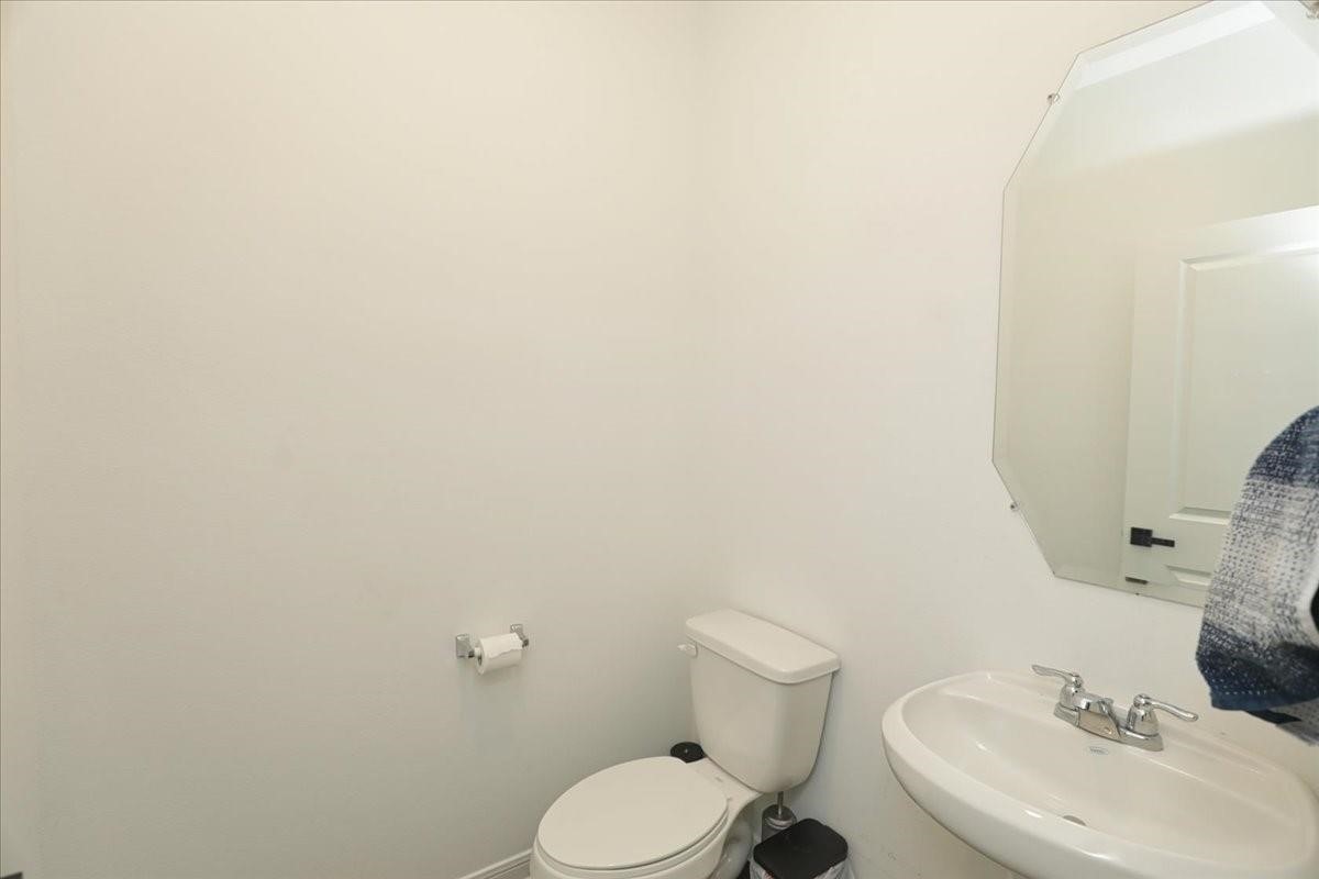 14463 Cedar Br Lane Conroe, TX 77302 - Photo 44 of 50 a white toilet sitting next to a white sink