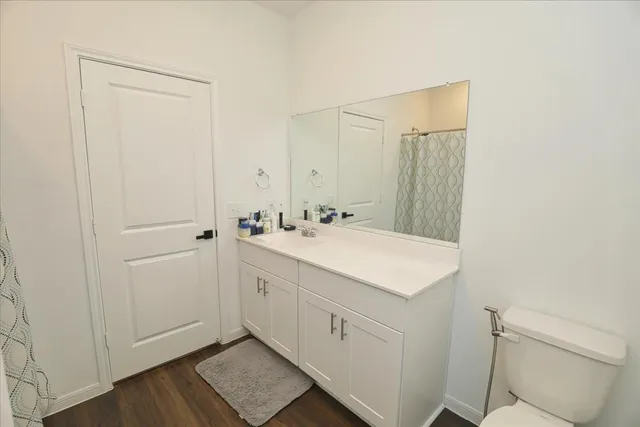a bathroom with a sink a toilet and a mirror