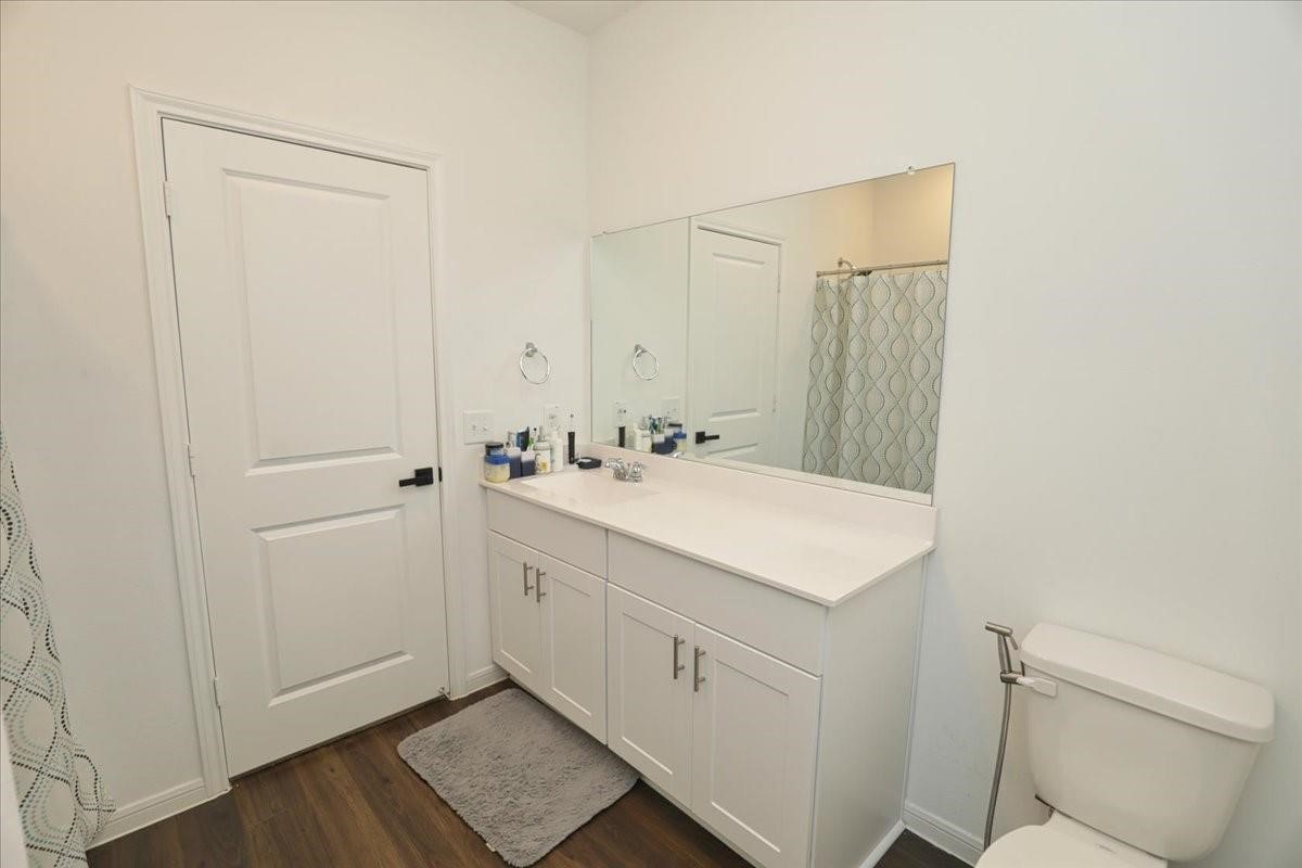14463 Cedar Br Lane Conroe, TX 77302 - Photo 46 of 50 a bathroom with a sink a toilet and a mirror