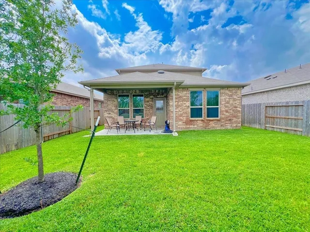 a view of a house with a backyard porch and sitting area