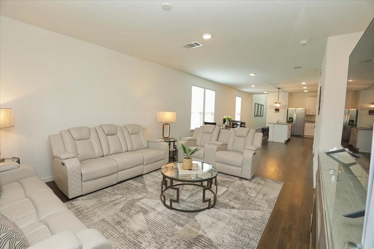 14463 Cedar Br Lane Conroe, TX 77302 - Photo 6 of 50 a living room with furniture and a large mirror with wooden floor