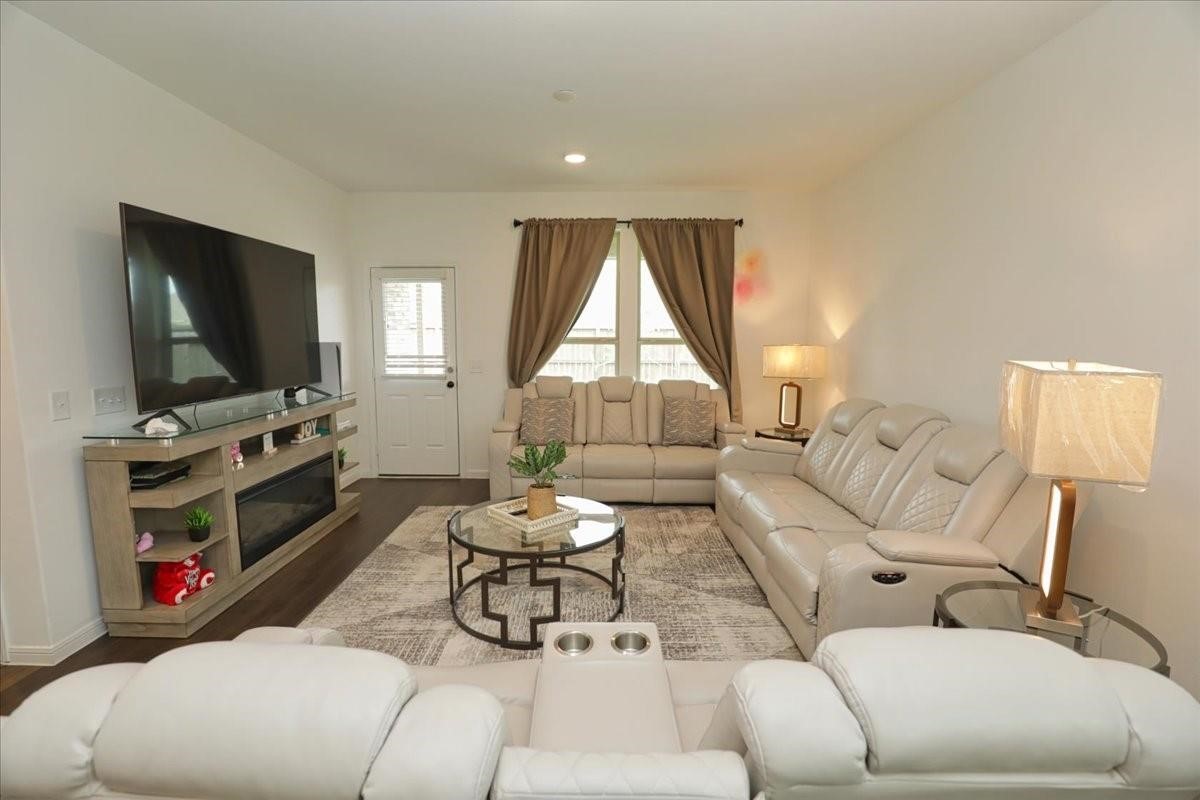 14463 Cedar Br Lane Conroe, TX 77302 - Photo 9 of 50 a living room with furniture a flat screen tv and a window