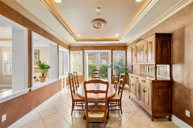 a dining room with furniture and large windows