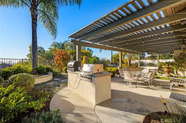 a view of a chairs and table in backyard of a house