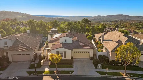 an aerial view of residential houses with outdoor space and swimming pool