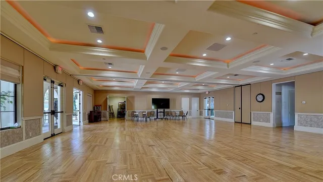 a view of a swimming pool with a yard and palm trees