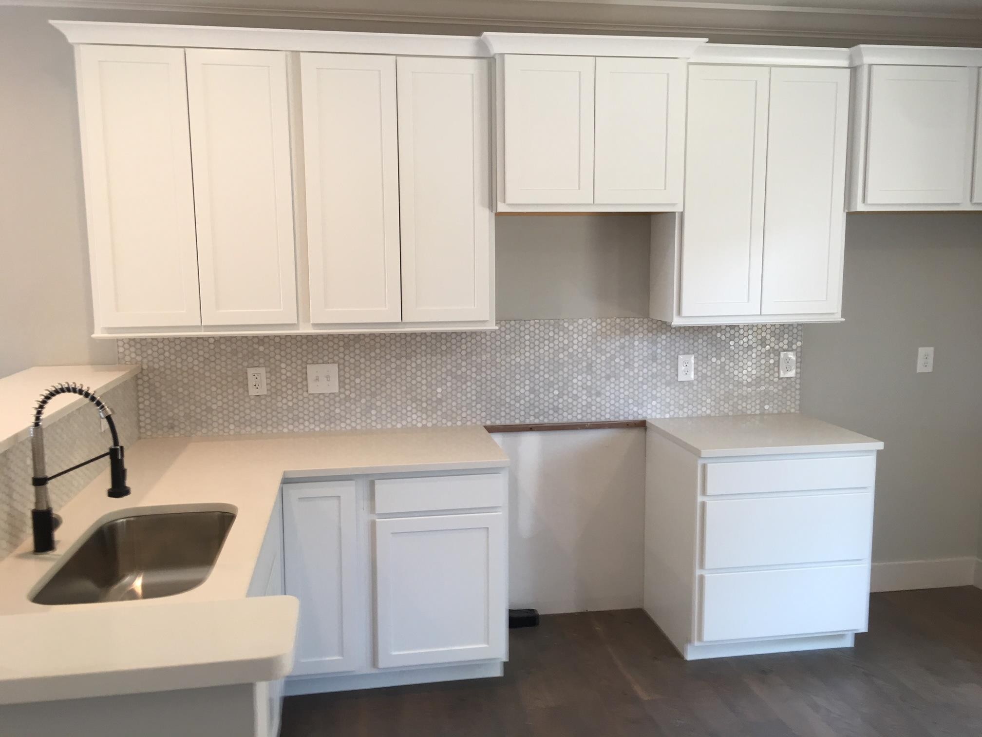 7110 Taylor Road Fairview, TN 37062 - Photo 5 of 23 a kitchen with white cabinets and a sink