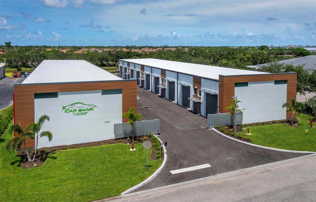 an aerial view of a house with garden space and street view