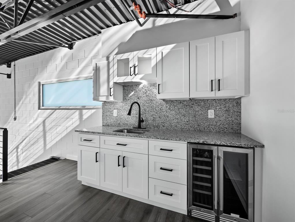 6562 Palmer Park Circle, Unit 18 Sarasota, FL 34238 - Photo 13 of 20 a kitchen with granite countertop a sink and cabinets