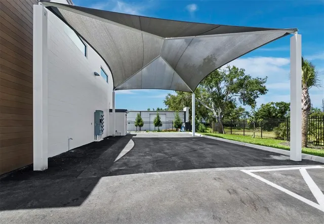 a view of a patio with a table and chairs under an umbrella