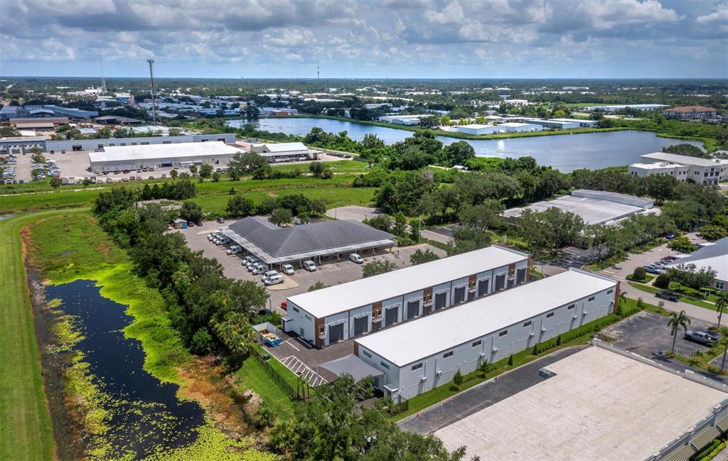 6562 Palmer Park Circle, Unit 18 Sarasota, FL 34238 - Photo 19 of 20 an aerial view of a house with a garden and lake view