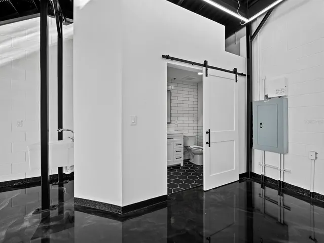 a view of a hallway with a door and couch