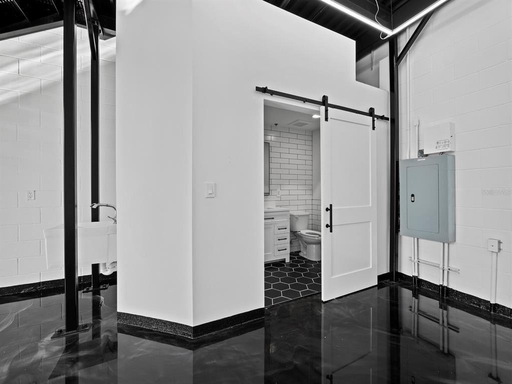 6562 Palmer Park Circle, Unit 18 Sarasota, FL 34238 - Photo 7 of 20 a view of a hallway with a door and couch