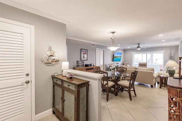 a view of a dining room with furniture and chandelier