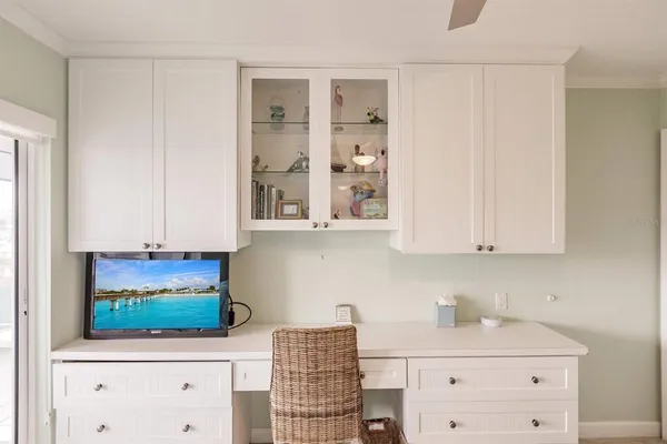 a kitchen with stainless steel appliances white cabinets and a stove top oven