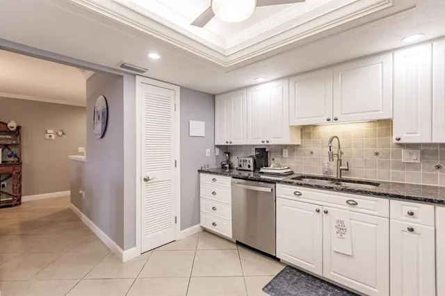 a kitchen with stainless steel appliances granite countertop a sink and cabinets