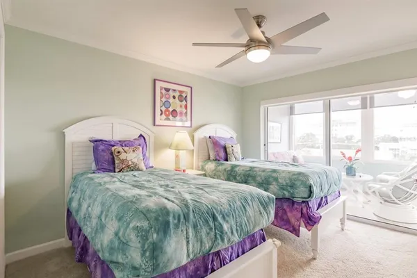 a bedroom with a bed and a large window with the outer view