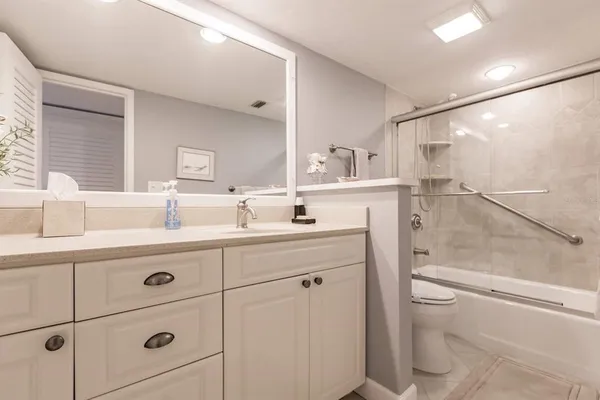 a bathroom with a sink a toilet and vanity