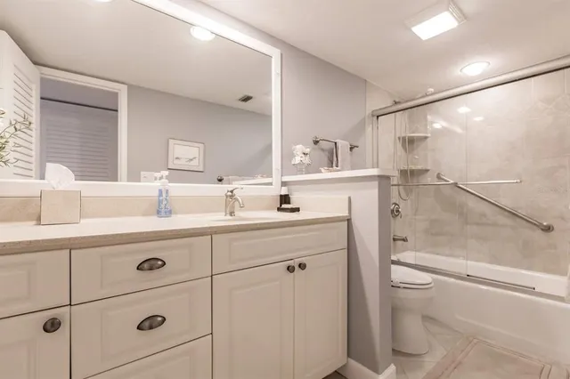 a bathroom with a sink a toilet and vanity