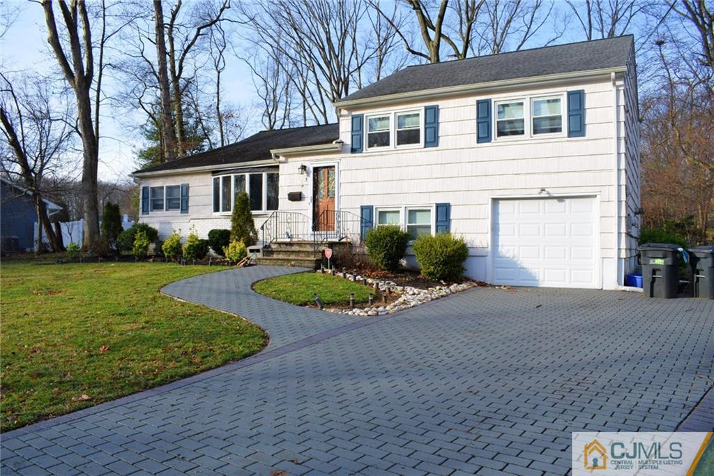 3 Timber Road East Brunswick, NJ 08816 - Photo 2 of 21 a front view of a house with a yard and potted plants