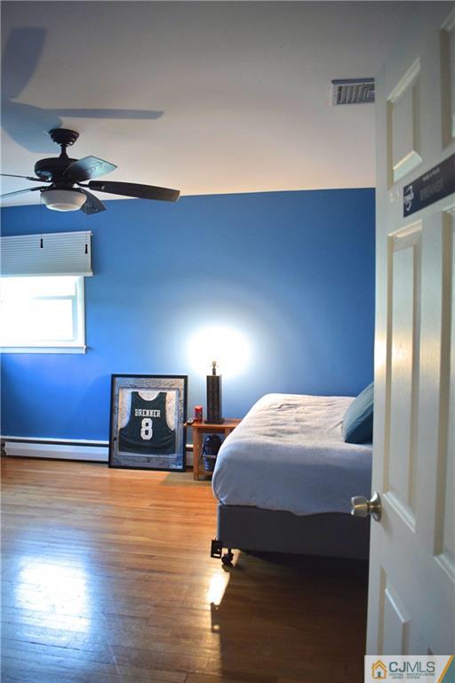 3 Timber Road East Brunswick, NJ 08816 - Photo 18 of 21 a bedroom with a bed and wooden floor