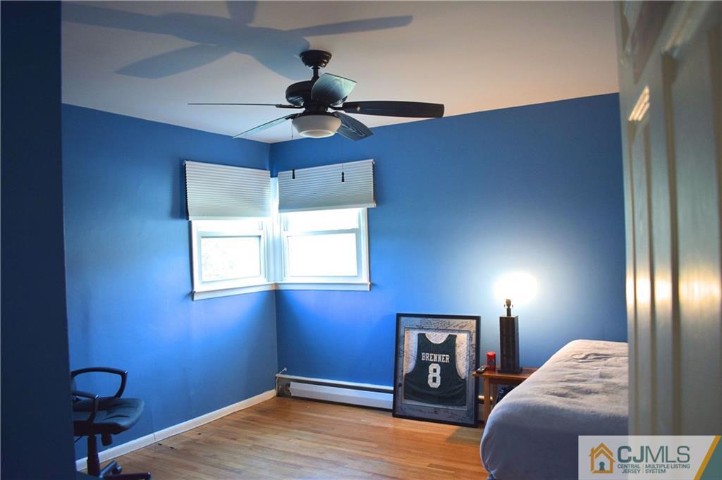 3 Timber Road East Brunswick, NJ 08816 - Photo 19 of 21 a bedroom with a bed and a chandelier