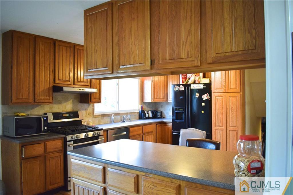 3 Timber Road East Brunswick, NJ 08816 - Photo 6 of 21 a kitchen with granite countertop wooden cabinets a sink and dishwasher