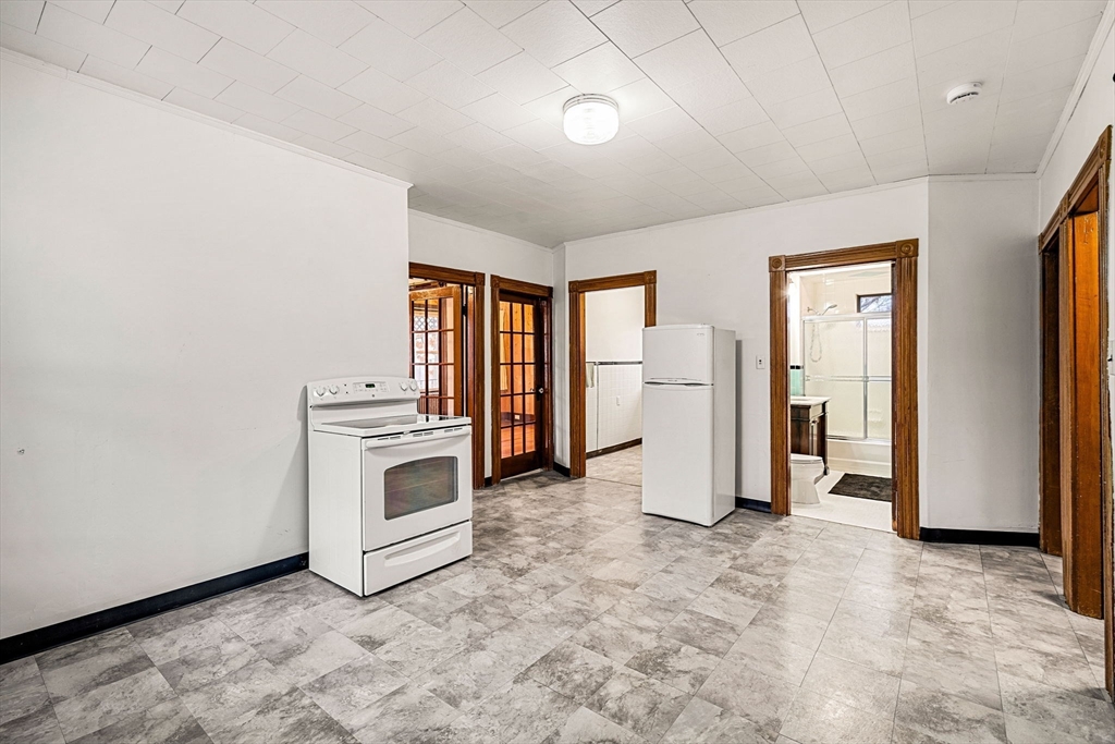 11 Devonshire Street Lawrence, MA 01843 - Photo 12 of 41 a view of a kitchen with refrigerator and cabinet