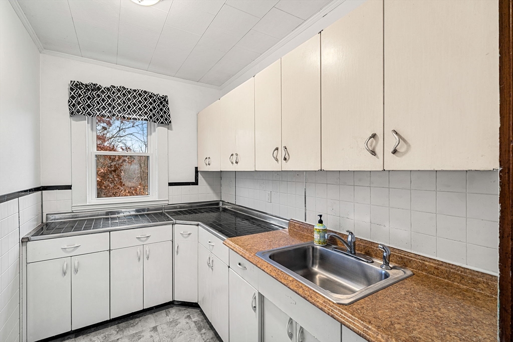 11 Devonshire Street Lawrence, MA 01843 - Photo 15 of 41 a kitchen that has a sink and cabinets