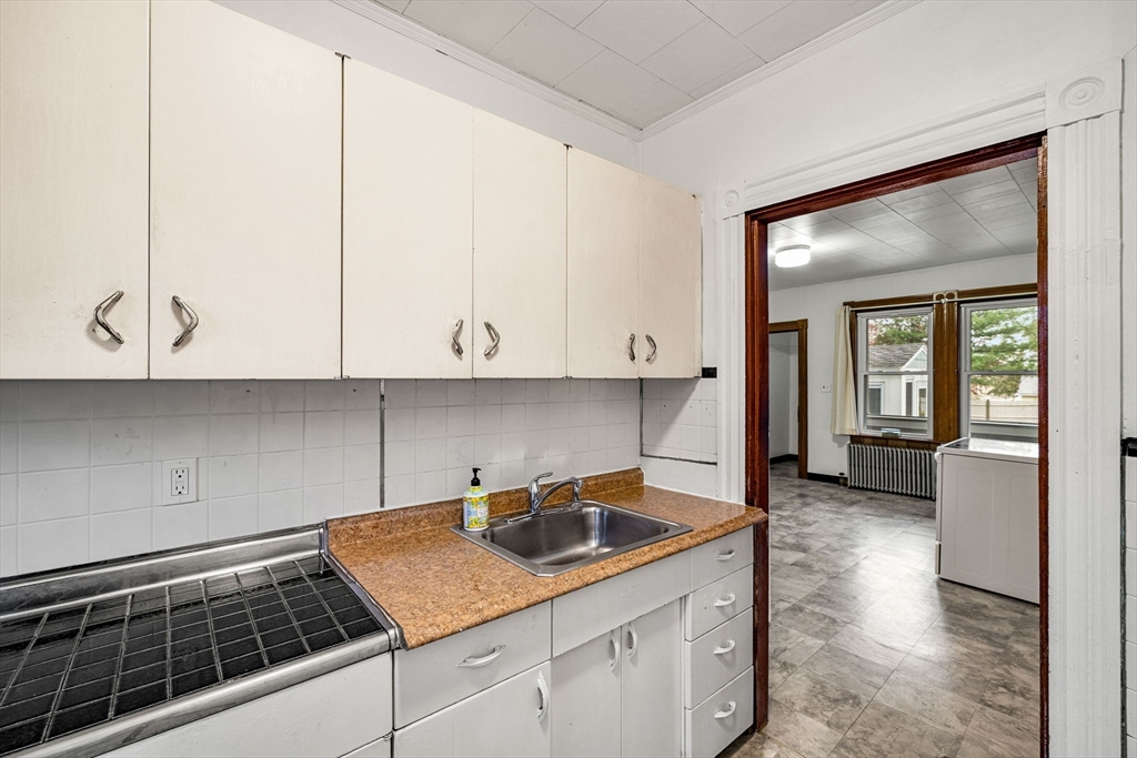 11 Devonshire Street Lawrence, MA 01843 - Photo 16 of 41 a kitchen with a sink and cabinets