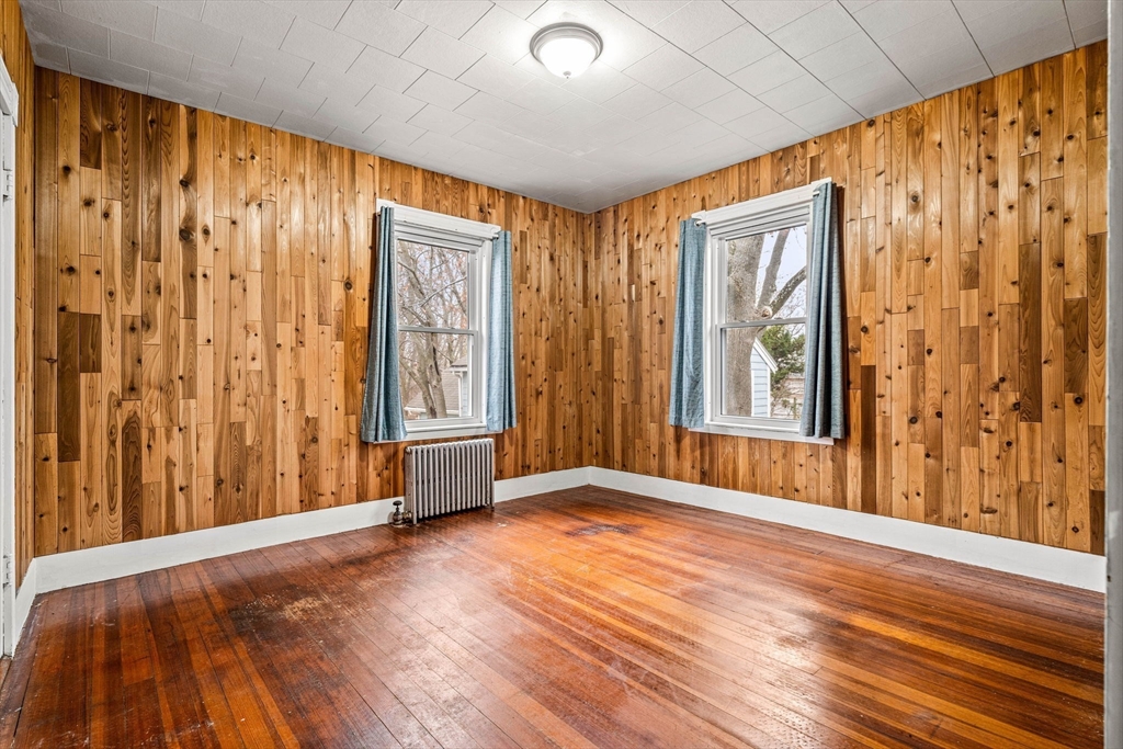 11 Devonshire Street Lawrence, MA 01843 - Photo 17 of 41 a view of an empty room with window and wooden floor