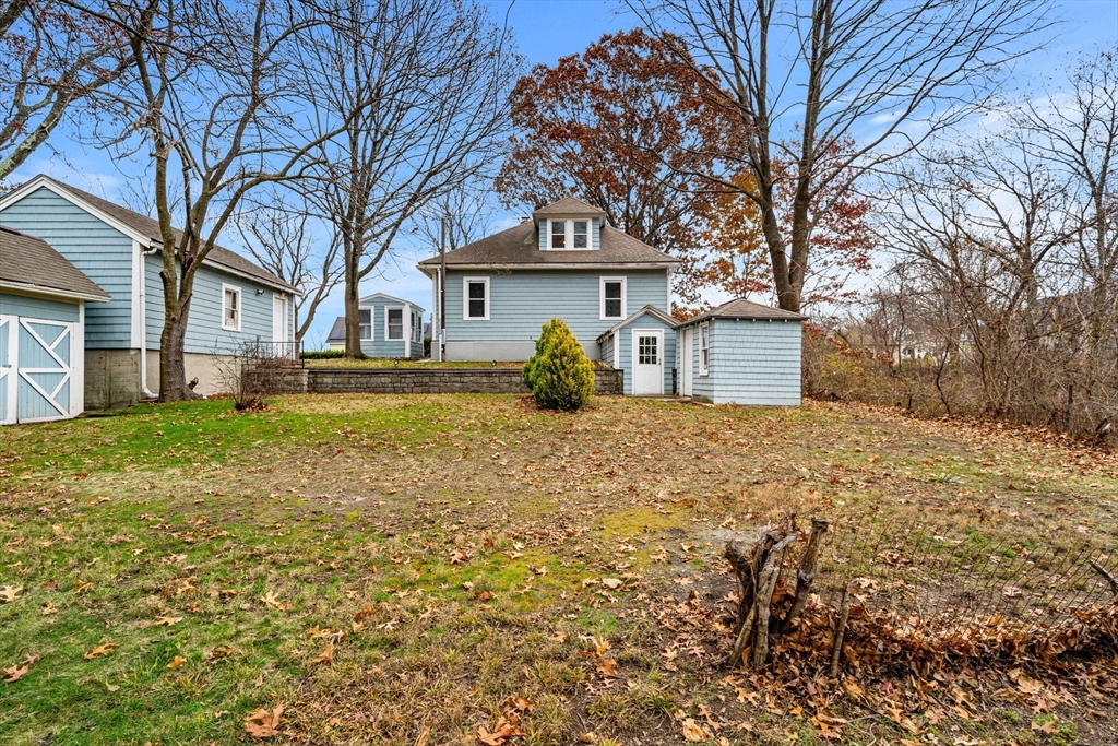 11 Devonshire Street Lawrence, MA 01843 - Photo 33 of 41 a front view of a house with large trees and a tree