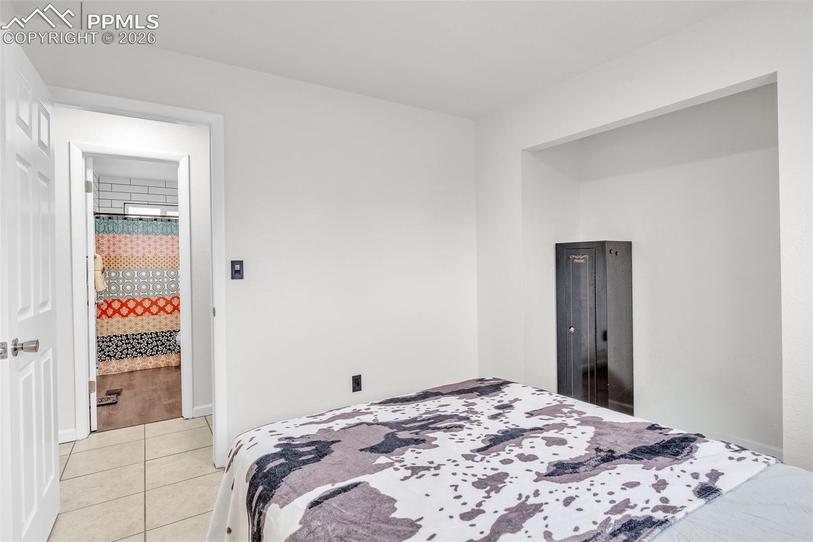1498 Peterson Road Colorado Springs, CO 80915 - Photo 23 of 44 Bedroom with light tile patterned floors