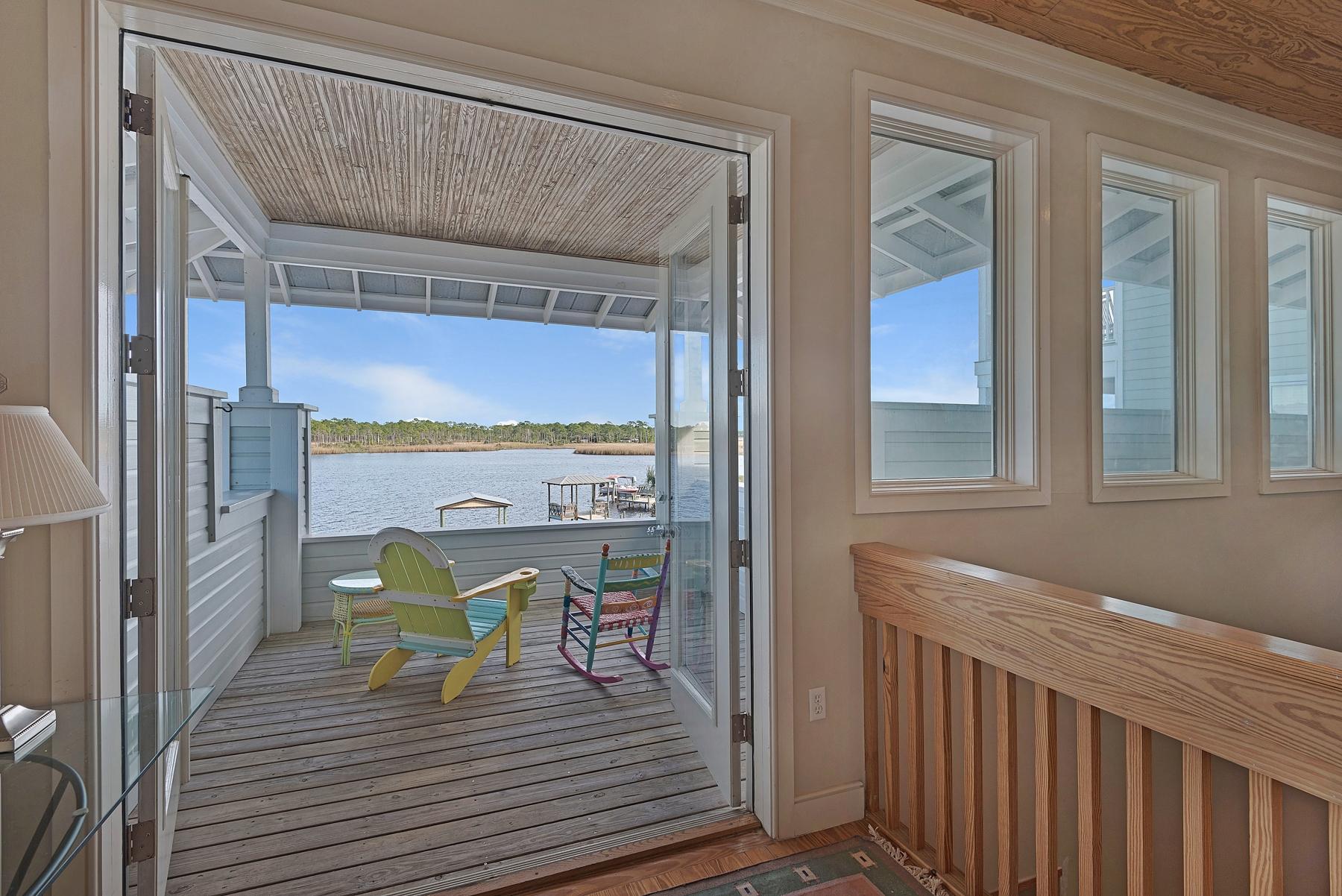 139 Banfill Road Santa Rosa Beach, FL 32459 - Photo 2 of 46 a view of a balcony dining table and chairs