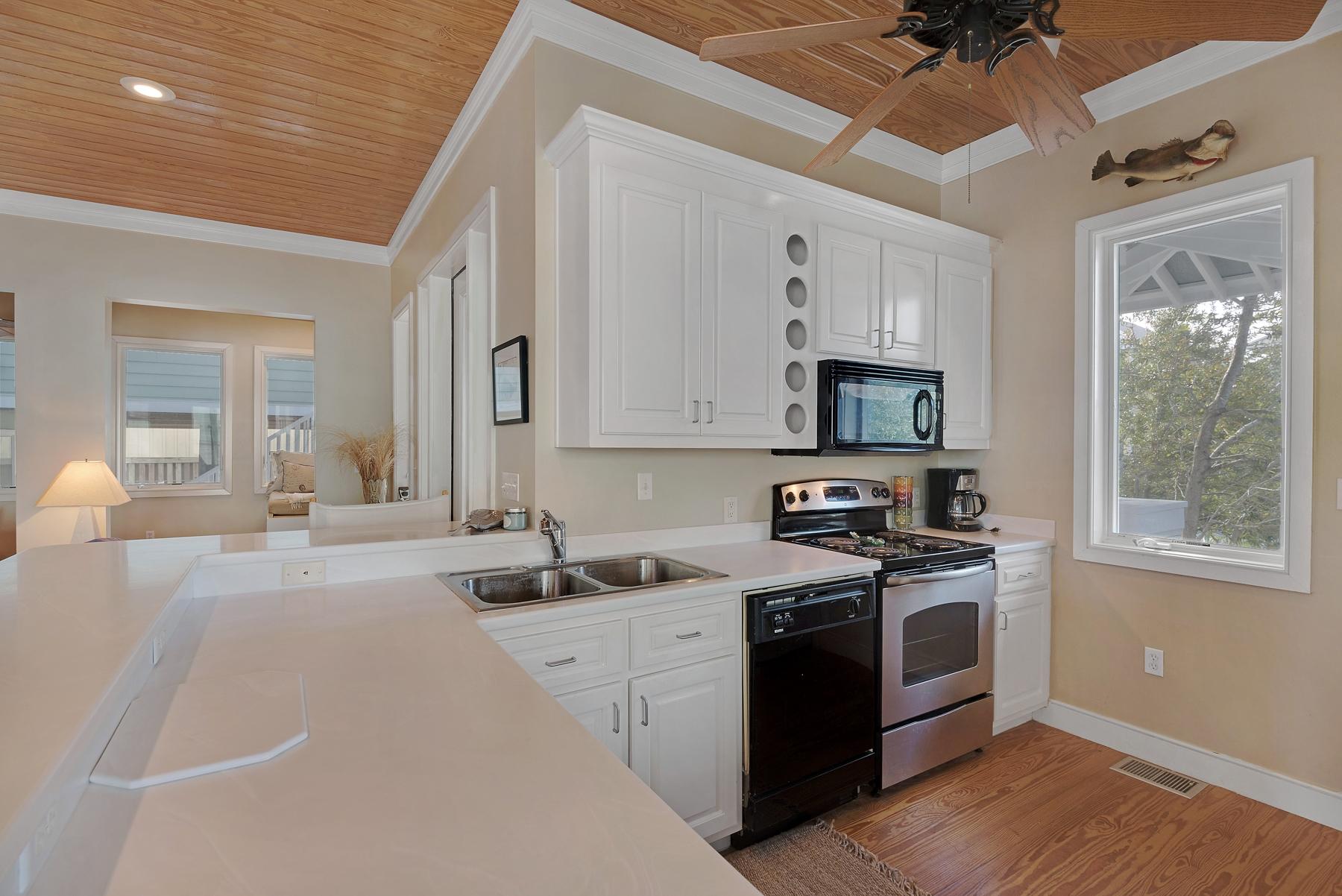 139 Banfill Road Santa Rosa Beach, FL 32459 - Photo 18 of 46 a kitchen with a sink stove and microwave