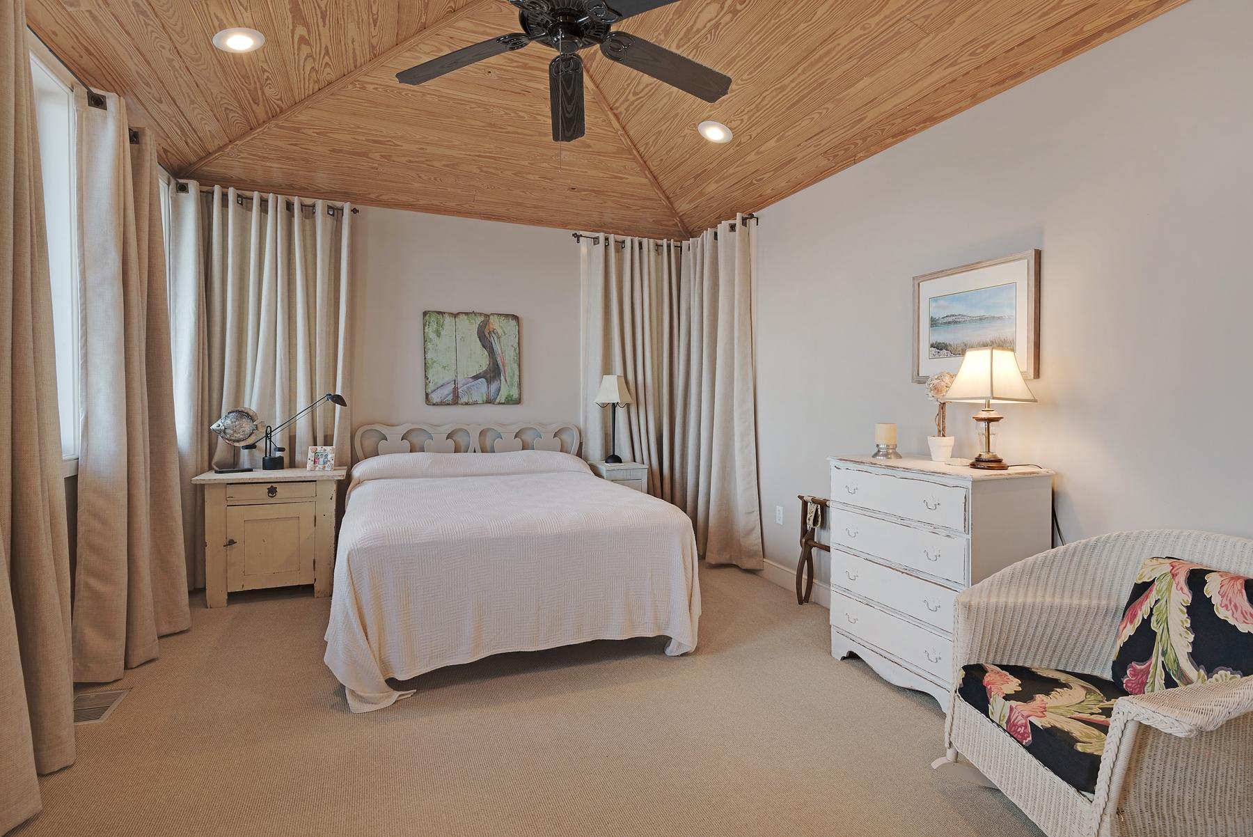 139 Banfill Road Santa Rosa Beach, FL 32459 - Photo 22 of 46 a bedroom with a bed and a chandelier