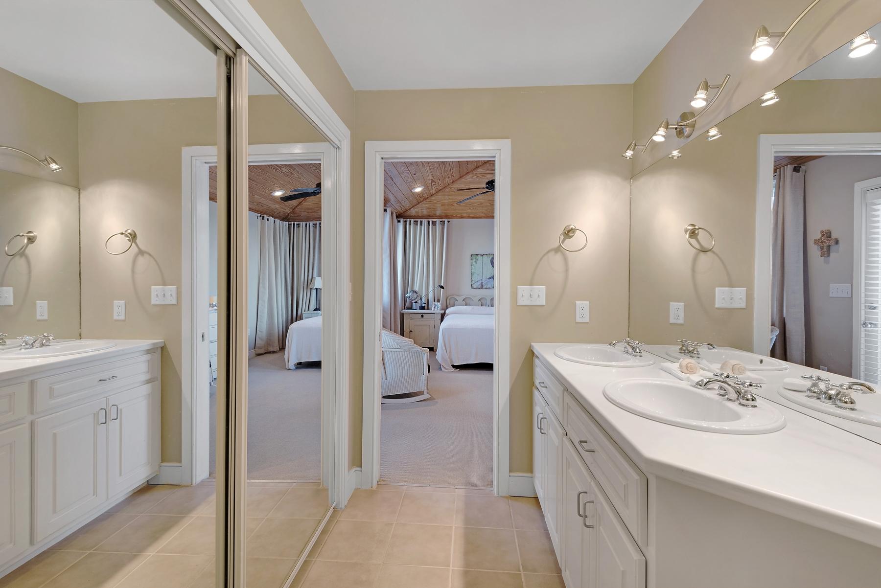 139 Banfill Road Santa Rosa Beach, FL 32459 - Photo 26 of 46 a en suite bathroom with a double vanity sink a mirror and shower