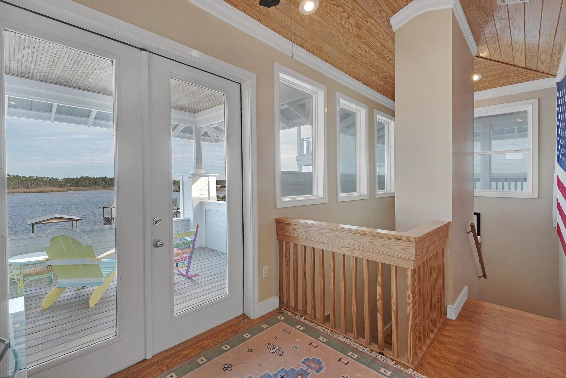 139 Banfill Road Santa Rosa Beach, FL 32459 - Photo 28 of 46 a view of a hallway with wooden floor and windows