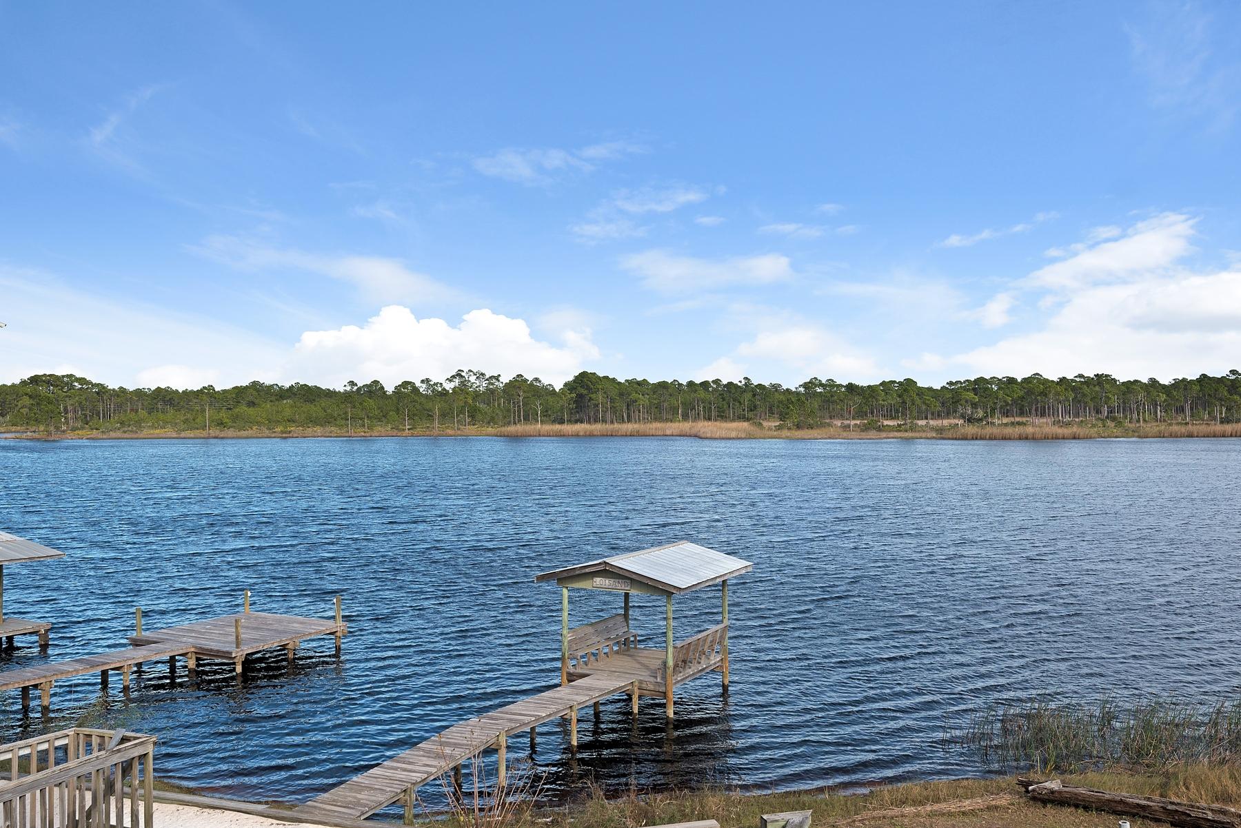 139 Banfill Road Santa Rosa Beach, FL 32459 - Photo 31 of 46 a view of a lake with couches chairs