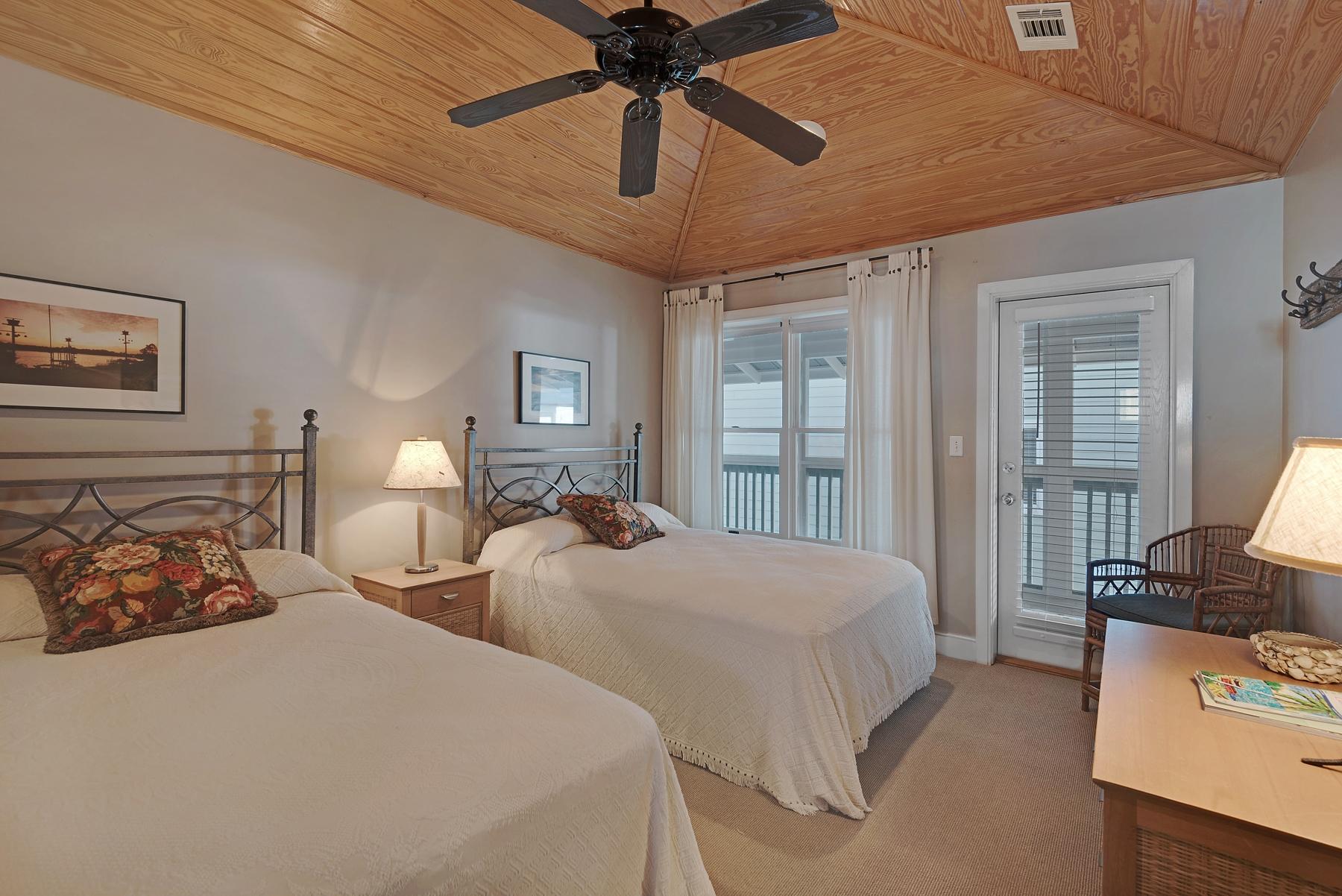 139 Banfill Road Santa Rosa Beach, FL 32459 - Photo 36 of 46 a bedroom with two beds and a chandelier