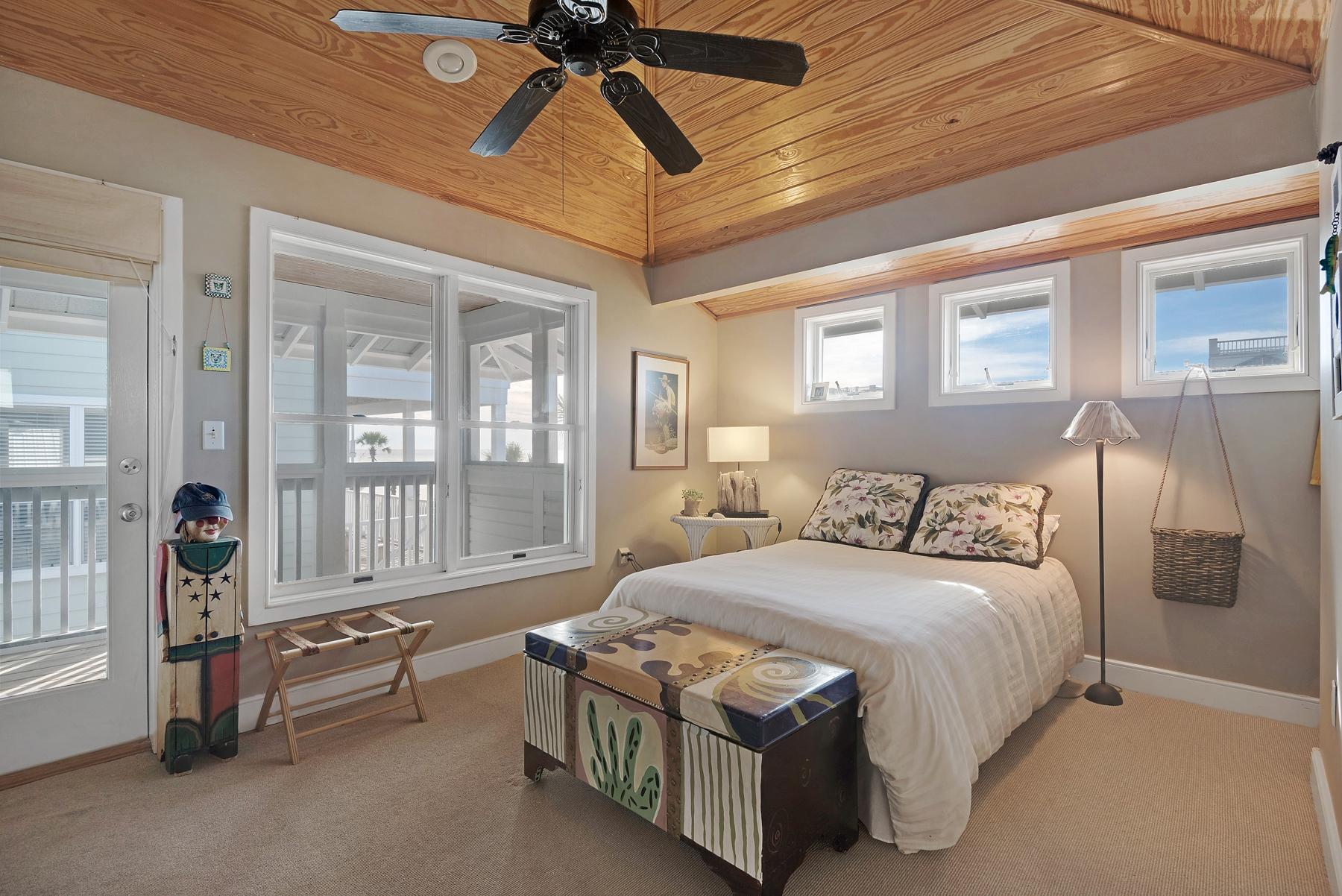 139 Banfill Road Santa Rosa Beach, FL 32459 - Photo 6 of 46 a bedroom with a bed and a chandelier