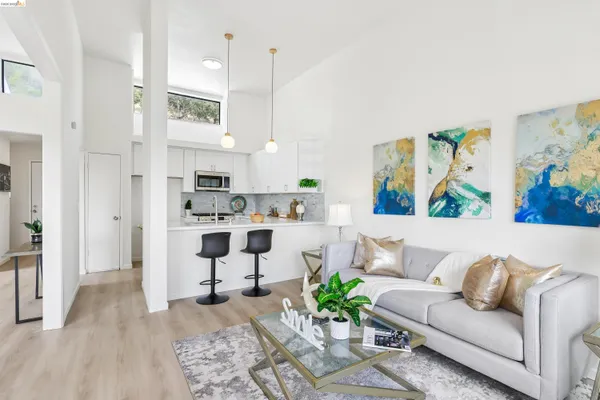 a living room with furniture and a kitchen area