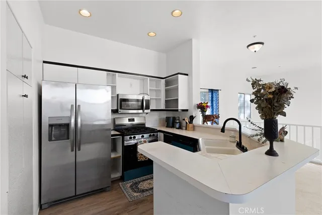a kitchen with refrigerator a sink and cabinets