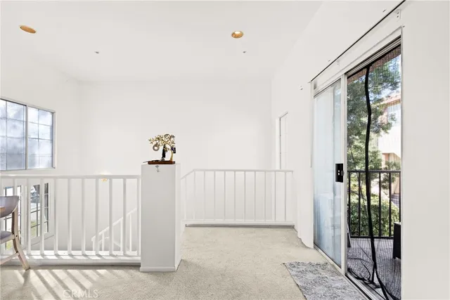 a view of a balcony with wooden floor and windows