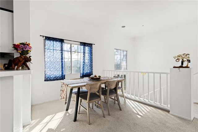 a view of a dining room with furniture and a window