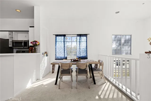 a view of a dining room with furniture and a window