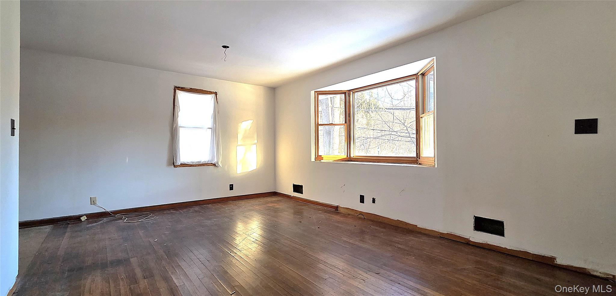 1716 A Main Street Peekskill, NY 10566 - Photo 5 of 13 a view of an empty room with wooden floor and a window